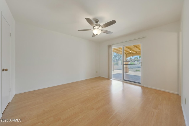 unfurnished room with baseboards, ceiling fan, and light wood finished floors