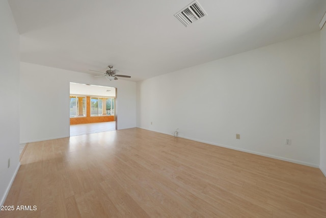 unfurnished room featuring baseboards, light wood-style floors, visible vents, and ceiling fan