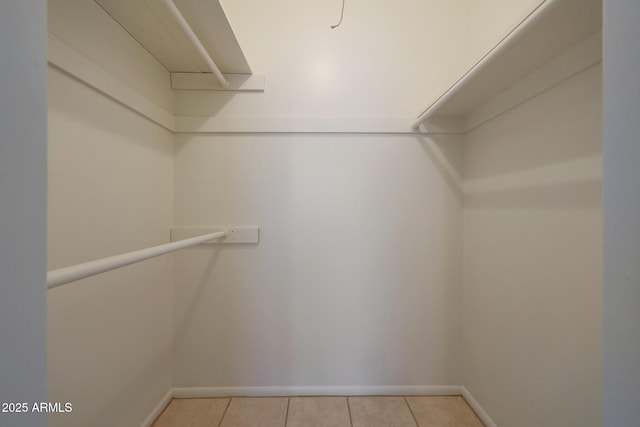 spacious closet with light tile patterned floors