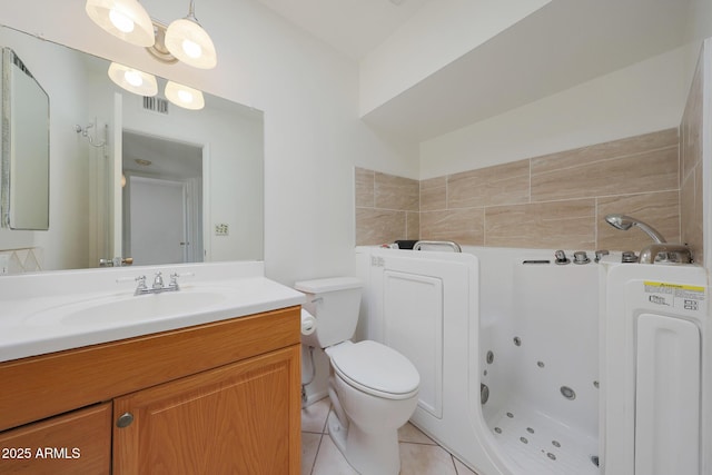 bathroom featuring tile patterned floors, visible vents, toilet, a jetted tub, and vanity