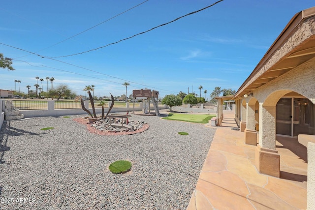 view of yard featuring fence and a patio area