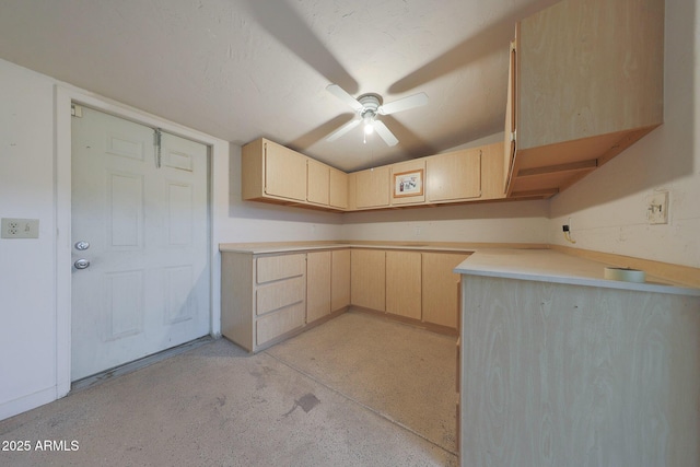 kitchen with a ceiling fan, light brown cabinetry, light countertops, a textured ceiling, and light speckled floor