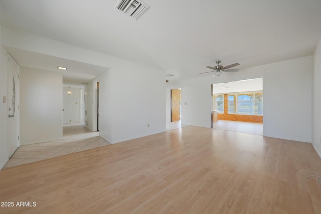 unfurnished living room featuring light wood-style flooring, visible vents, and ceiling fan