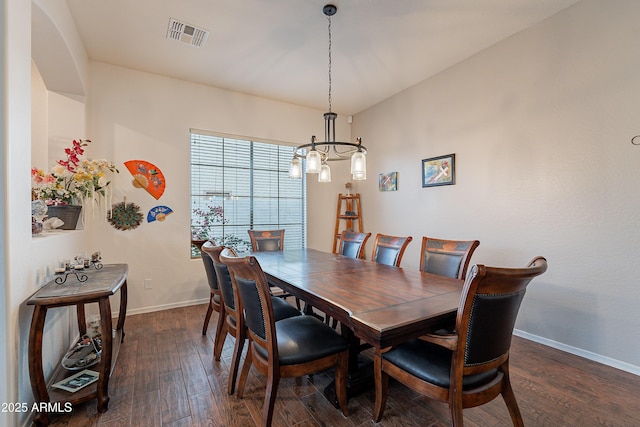 dining space featuring visible vents, dark wood finished floors, a notable chandelier, and baseboards