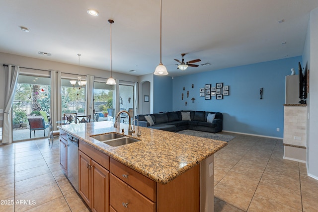 kitchen with arched walkways, visible vents, stainless steel dishwasher, a sink, and light stone countertops