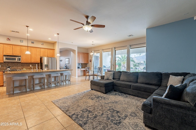 living room with light tile patterned floors, recessed lighting, visible vents, and a ceiling fan