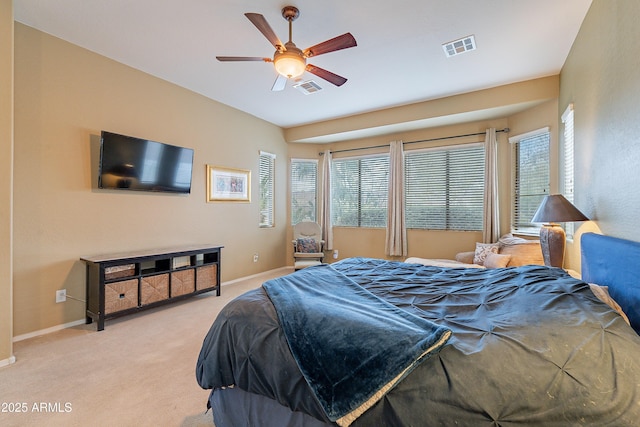 carpeted bedroom featuring ceiling fan, visible vents, and baseboards