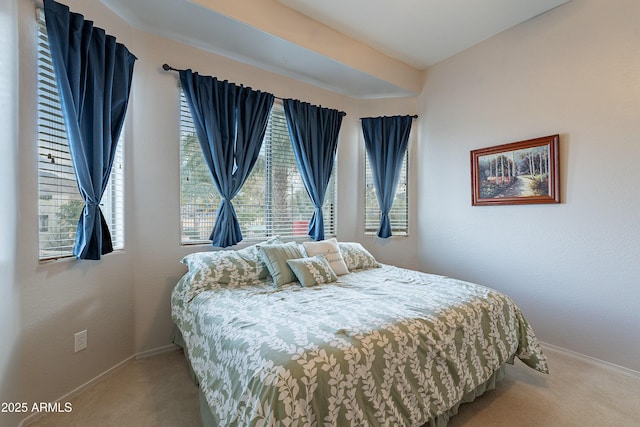 bedroom featuring carpet and baseboards