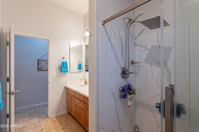 full bath with tile patterned floors, a marble finish shower, and vanity