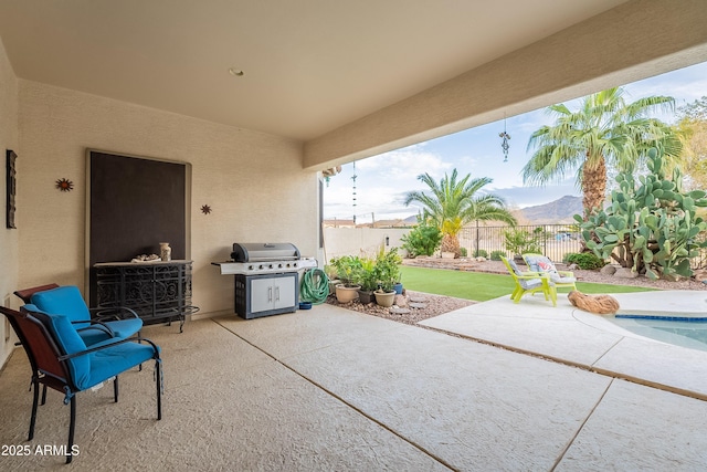 view of patio / terrace featuring fence, a fenced in pool, and area for grilling