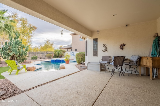 view of swimming pool with a patio area, a fenced backyard, and a pool with connected hot tub