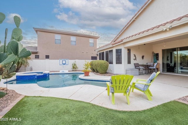 view of swimming pool with outdoor dining space, a pool with connected hot tub, fence, and a patio