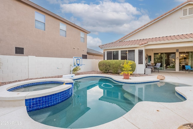 view of swimming pool featuring a patio, a fenced backyard, and a pool with connected hot tub