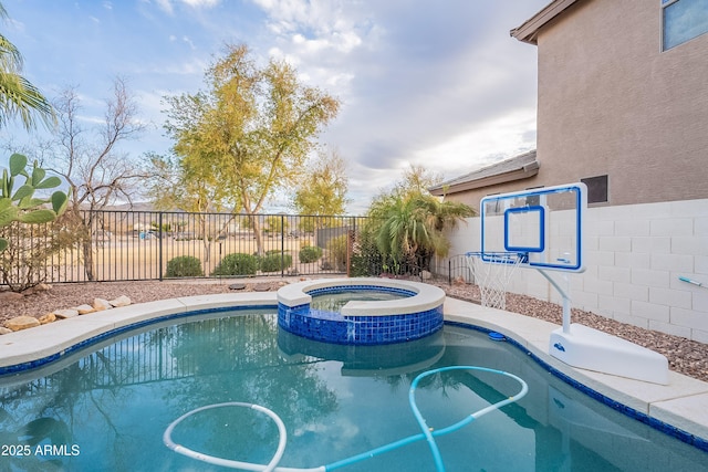 view of pool with a pool with connected hot tub and fence