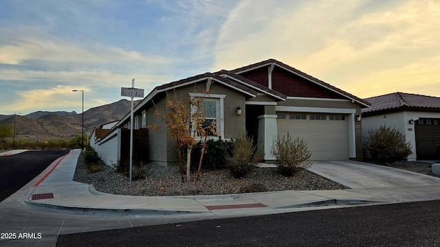 view of front of home featuring a garage and a mountain view