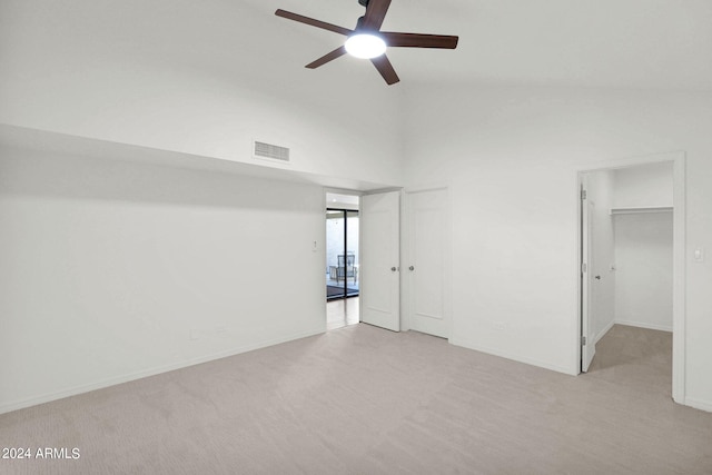 carpeted spare room with vaulted ceiling and ceiling fan