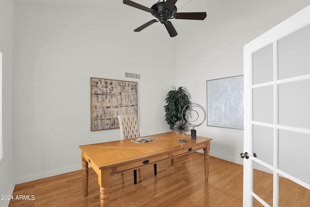 home office featuring hardwood / wood-style floors, french doors, and ceiling fan