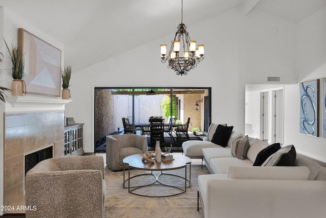 living room with beam ceiling, an inviting chandelier, high vaulted ceiling, and a tiled fireplace