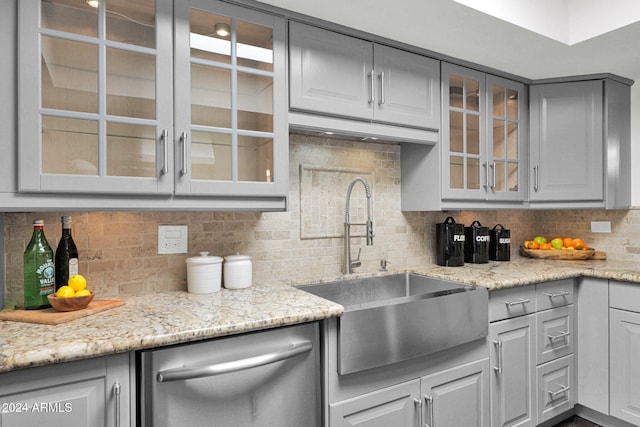 kitchen with dishwasher, sink, gray cabinetry, and backsplash