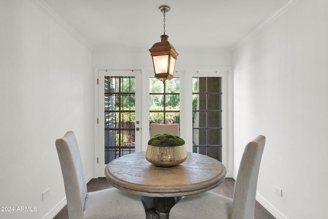 dining room featuring ornamental molding and dark hardwood / wood-style floors