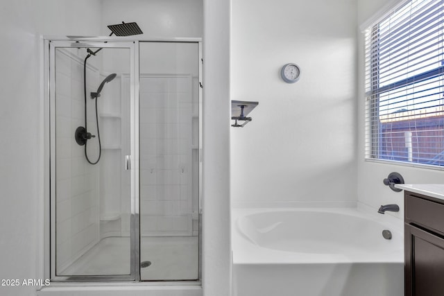 bathroom featuring separate shower and tub and vanity