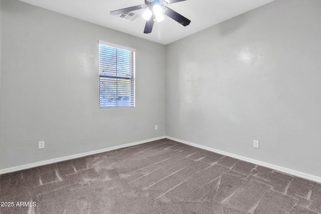 carpeted spare room featuring ceiling fan