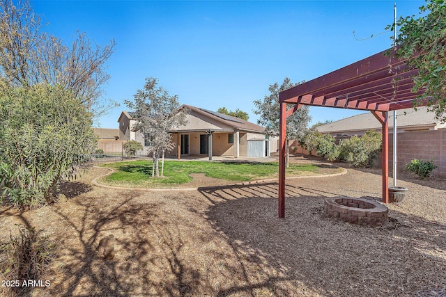 view of yard with a pergola, an outdoor structure, and a fire pit