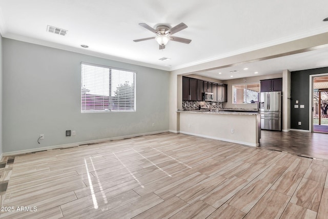 unfurnished living room with ceiling fan and ornamental molding