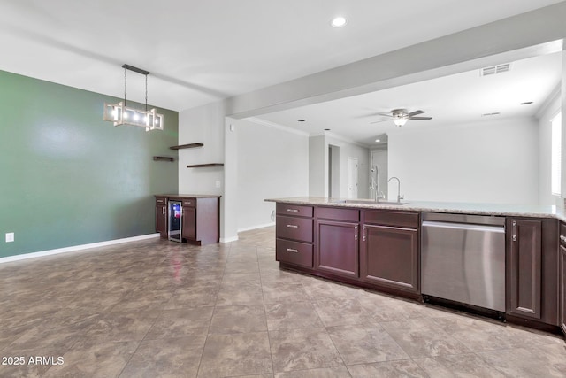 kitchen featuring stainless steel dishwasher, decorative light fixtures, dark brown cabinets, ceiling fan with notable chandelier, and sink