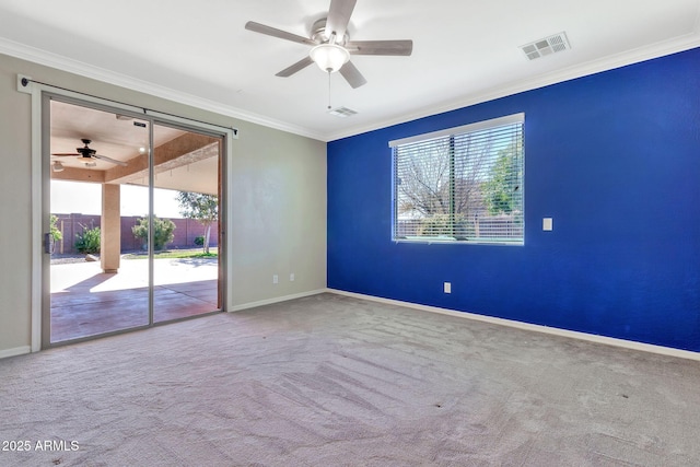 spare room with ceiling fan, ornamental molding, and carpet floors