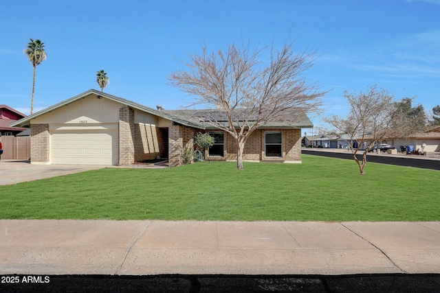 view of front of house featuring an attached garage, driveway, brick siding, and a front yard