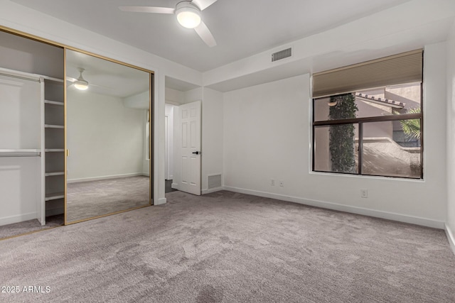 unfurnished bedroom with carpet floors, a closet, and ceiling fan