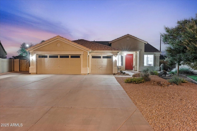 3604 E Derringer Way, Gilbert, AZ 85297 - view of front facade with stucco siding, an attached garage, driveway, and fence