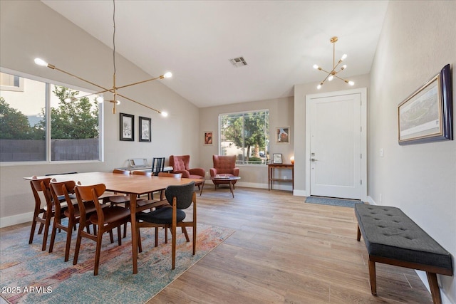 3604 E Derringer Way, Gilbert, AZ 85297 - dining space featuring a chandelier, light wood-type flooring, baseboards, and high vaulted ceiling