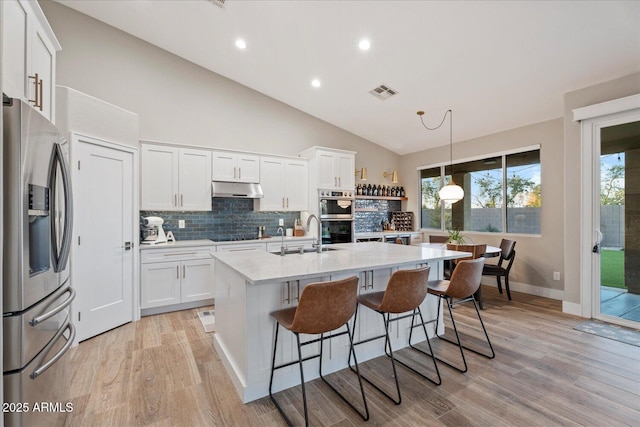 3604 E Derringer Way, Gilbert, AZ 85297 - kitchen with stainless steel appliances, a sink, light countertops, under cabinet range hood, and decorative backsplash