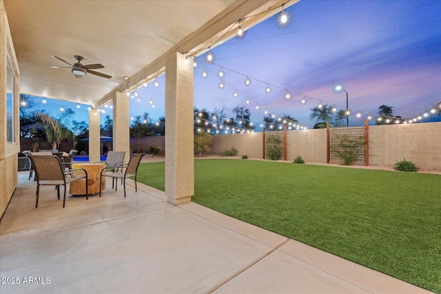 3604 E Derringer Way, Gilbert, AZ 85297 - patio terrace at dusk featuring a ceiling fan and outdoor dining area