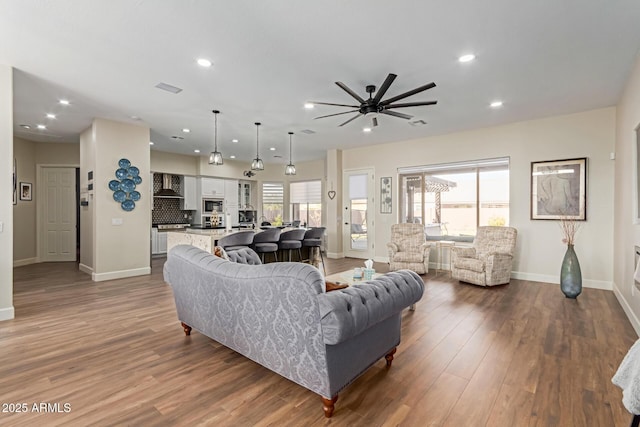 living room featuring hardwood / wood-style floors and ceiling fan