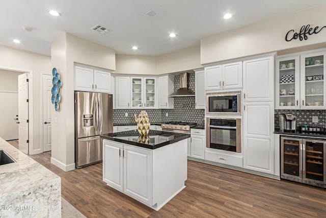 kitchen with white cabinetry, beverage cooler, and appliances with stainless steel finishes