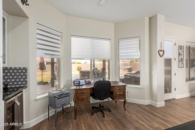 office area with dark hardwood / wood-style floors and beverage cooler