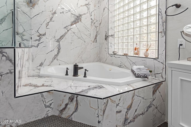 bathroom with a relaxing tiled tub