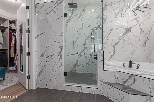 bathroom featuring tile patterned floors and shower with separate bathtub