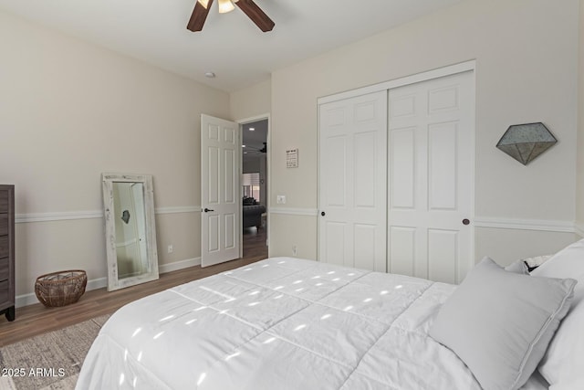 bedroom with ceiling fan, dark hardwood / wood-style flooring, and a closet