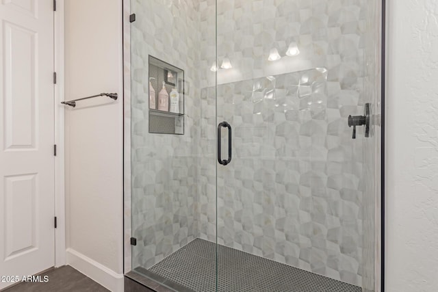 bathroom featuring a shower with door