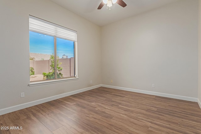 spare room with hardwood / wood-style flooring and ceiling fan