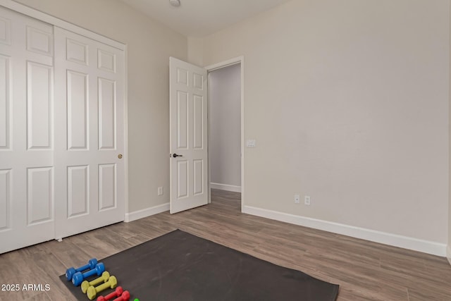 unfurnished bedroom with hardwood / wood-style flooring and a closet