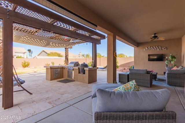 view of patio / terrace featuring ceiling fan, a pergola, area for grilling, an outdoor hangout area, and exterior kitchen