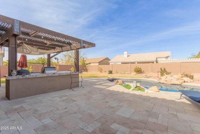 view of patio featuring a fenced in pool, area for grilling, a pergola, and exterior kitchen