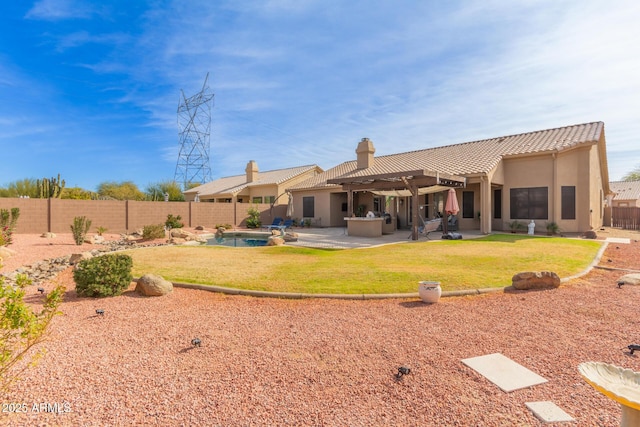 back of house with a fenced in pool, a yard, and a patio