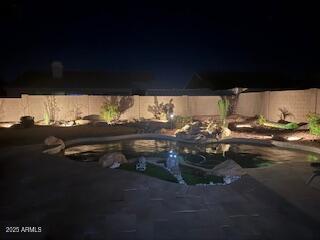 pool at twilight featuring a patio