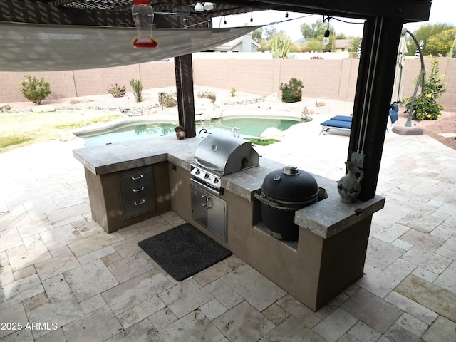 view of patio / terrace featuring area for grilling and a fenced in pool